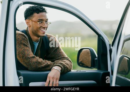 Smiling man leaning on van door Stock Photo