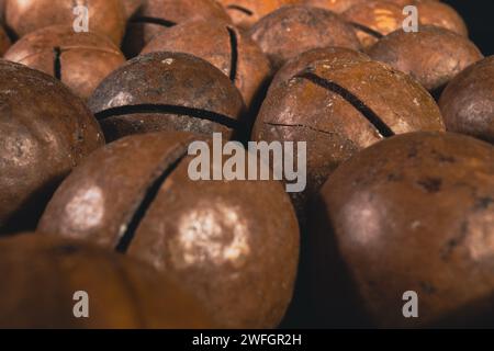 Macadamia nut in a shell close up. Macadamia nuts texture background. Macadamia nuts macro. Stock Photo