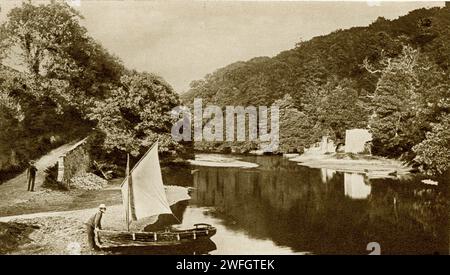 Photograph of fisherman and his boat at  Old Mill Creek,  River Dart, near the Royal Navy College, Dartmouth.  From the book Glorious Devon.  by S.P.B. Mais, published by London Great Western Railway Company, 1928. The photo is probably older, from around 1910. Stock Photo