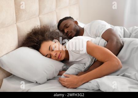 Loving young black couple having cozy morning cuddling in sleep Stock Photo