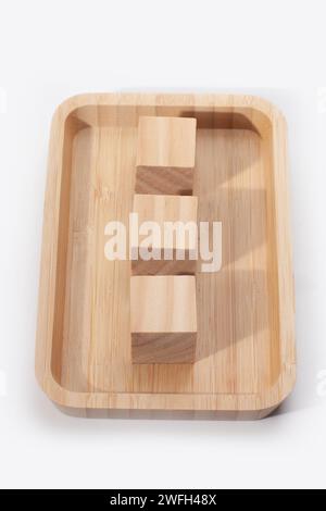 wooden tray with cubes isolated on white surface Stock Photo