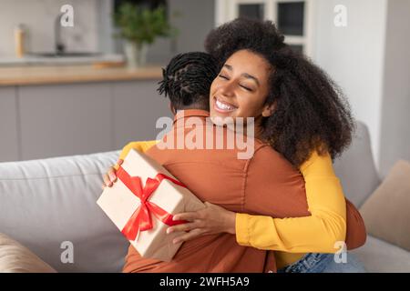 Thankful african lady hugging her husband, cooking together Stock Photo ...