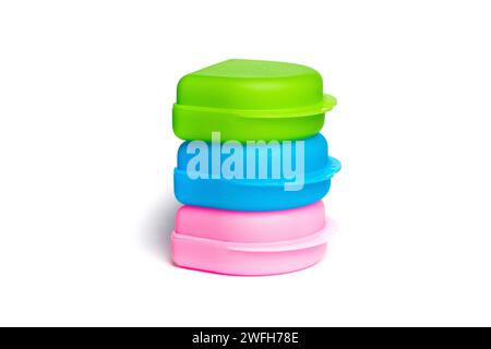Colorful plastic box package isolated on white background. Green, blue and pink case Stock Photo