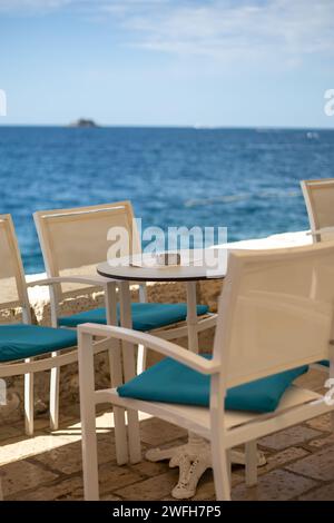 close up of table setting at open-air cafe on beach Stock Photo