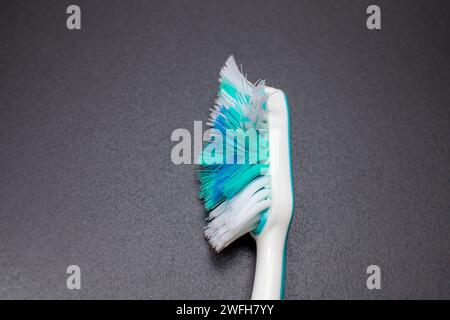 used toothbrush isolated on dark background Stock Photo