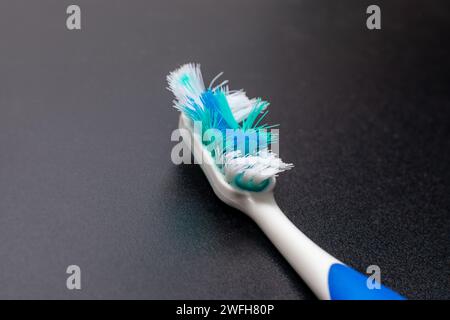 used toothbrush isolated on dark background Stock Photo