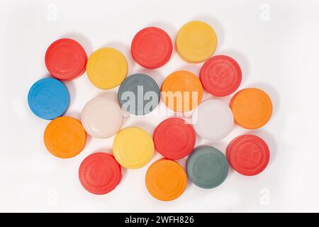 many colorful plastic bottle caps isolated on white surface Stock Photo