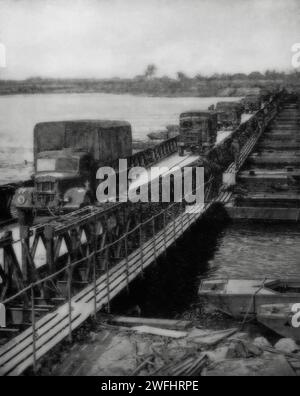 On the 25th March 1945, Allied supplies pour across a pontoon bridge over the River Rhine in Germany during the final days of the Second World War in Europe. Stock Photo