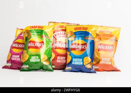 London, United Kingdom, 29th January 2024:- A selection of Walkers British Potato Crisps on a white background Stock Photo