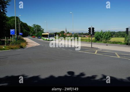Road junction at the entrance to the car park at Britford Park and Ride, near Salisbury, Wiltshire, as a bus arrives. Stock Photo