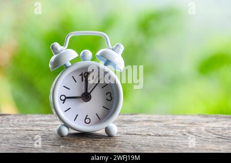 Table alarm clock pointing at 9 am. Time concept and copy space Stock Photo