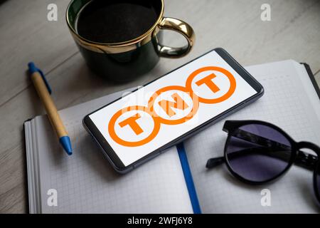 In this photo illustration a TNT logo seen displayed on a smartphone. Stock Photo