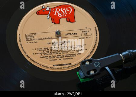Eric Clapton 461 Ocean Boulevard vinyl record album LP with tonearm, cartridge, headshell and stylus on turntable record player - 1974 Stock Photo