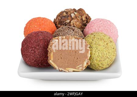 A variety of different truffles in a ceramic bowl Isolated on a white background Stock Photo