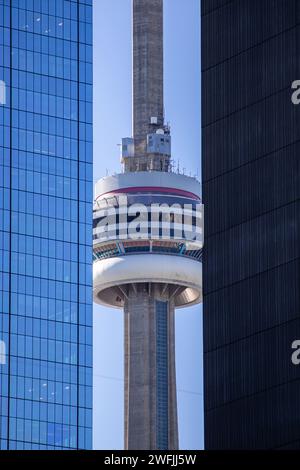 A Close up of the CN Tower between two buildings - Toronto, Ontario Stock Photo