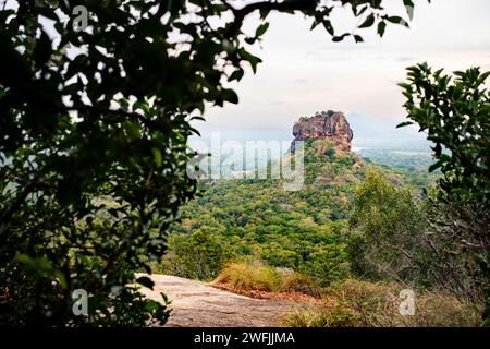 Sigiriya, Sri Lanka. Lion's Rock from Pidurangala mountain. Travel in Dambulla, Srilanka. Tourism in world heritage site. Green forest trekking. Stock Photo