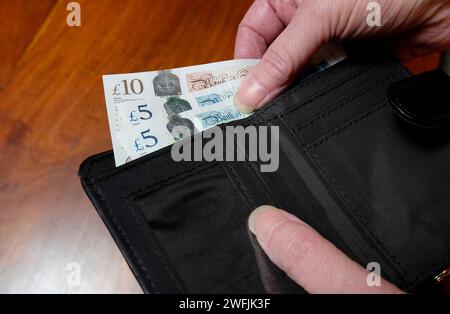female person taking british money from wallet Stock Photo