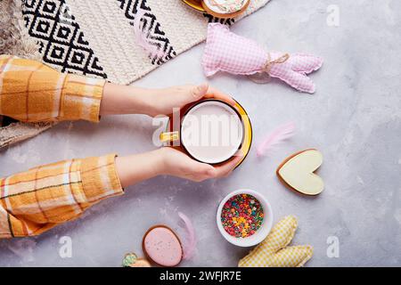 Tasty Easter traditions. Easter vibes for kids. Happy Easter. Sweet cocoa and cookies. Stock Photo