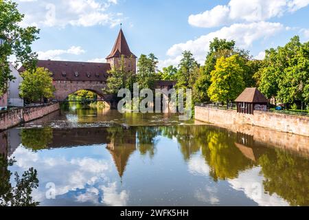 The Fronveste building and the Schlayerturm (tower) are part of the fortifications of the old town of Nuremberg, Germany, on the Pegnitz river. Stock Photo