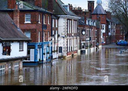 River Ouse burst banks after heavy rain (riverside road submerged under high flood water, pub premises flooded) - York, North Yorkshire, England, UK. Stock Photo