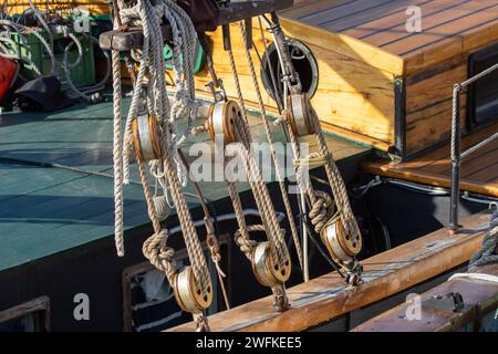 Wooden blocks with ropes on an old varnished sailing ship Stock Photo