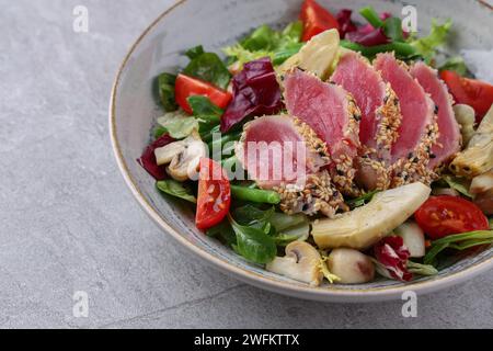 salad with carpaccio, artichoke and asparagus on a stone background, studio food photography 2 Stock Photo