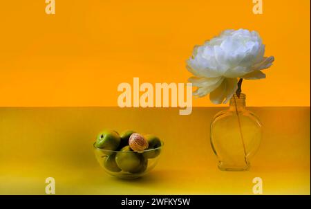 A large bouquet of white, yellow, red, autumn flowers. Many asters in a gray vase on a wooden staircase. Below are two red apples, a small pumpkin. Or Stock Photo