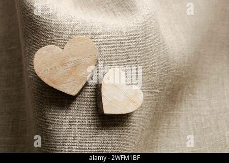 Wooden hearts on linen fabric. Graphic resources Stock Photo