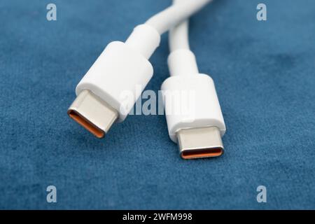 USB-C view of white USB-C plug on dark background. Stock Photo