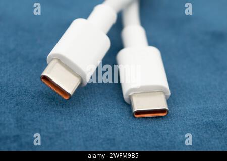 USB-C view of white USB-C plug on dark background. Stock Photo