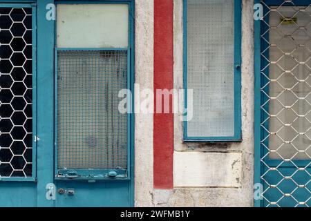 facade with old blue windows and shutters Stock Photo