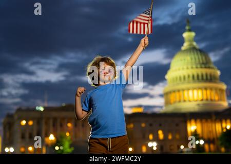Excited child hold American flag. Patriotic holiday. Kid boy with American flag in Washington DC. USA kids celebrate independence day 4th of July Stock Photo