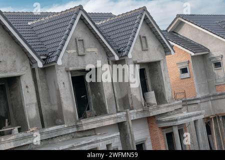 Residential construction. Building new houses in progress at construction site. Housing estate development Stock Photo