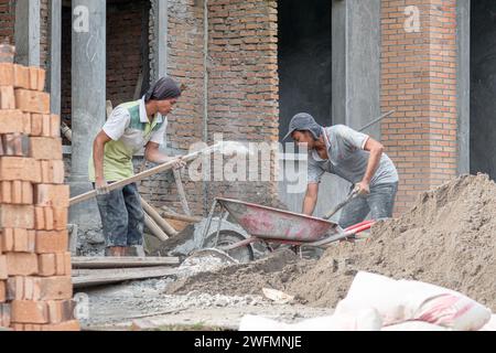 Asian construction workers doing their works in the morning. Building residential houses. Stock Photo