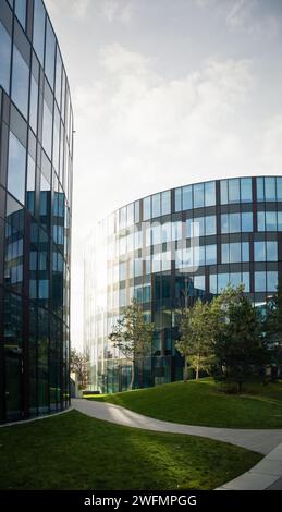 Two modern office buildings with a rounded, curved design and many ...