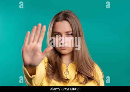 Uninterested woman disapproving with NO hand sign gesture. Denying, rejecting. Stock Photo