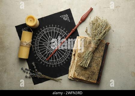 Flat lay composition with magic wand and divination cloth on light textured background Stock Photo