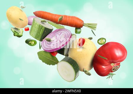 Different fresh vegetables and spices in air on light blue background Stock Photo