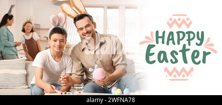 Greeting banner with happy father and son painting eggs for Easter celebration Stock Photo