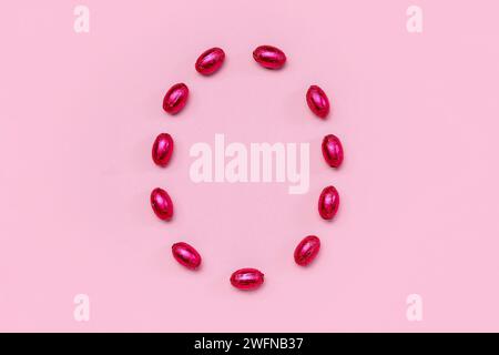 Easter egg made of chocolate candies on color background Stock Photo