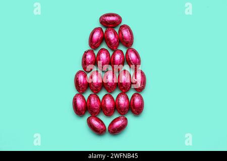 Easter egg made of chocolate candies in foil on color background Stock Photo
