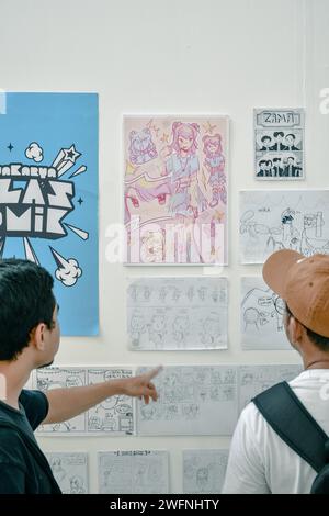 Two people are looking at a comic gallery exhibition Stock Photo
