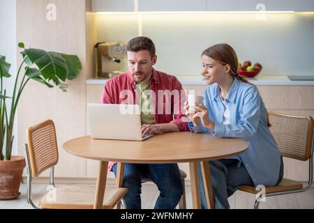 Married couple having video call with parents during work break of man working as freelancer at home Stock Photo