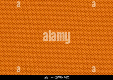 Solid orange color swatch of woven fabric on upholstery made from polyester, rayon or nylon material with macro details. Stock Photo