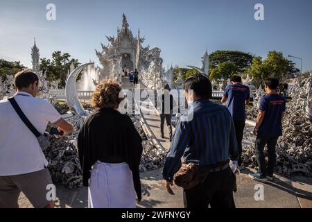 Chiang Rai, Thailand. 19th Jan, 2024. Tourists stand by at the White Temple. The 'Wat Rong Khun' most commonly known as the 'White Temple' was designed and constructed by famous Thai artist Chalermchai Kositpipat and opened to visitors in 1997. The Temple attracts a large number of visitors daily, both locals and tourists which makes it the number 1 attraction in Chiang Rai, Northern Thailand. (Photo by Guillaume Payen/SOPA Images/Sipa USA) Credit: Sipa USA/Alamy Live News Stock Photo