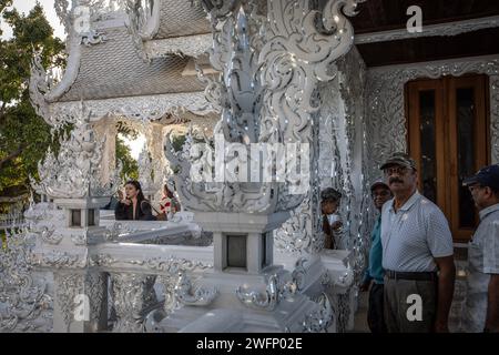 Chiang Rai, Thailand. 19th Jan, 2024. Tourists visiting the White Temple. The 'Wat Rong Khun' most commonly known as the 'White Temple' was designed and constructed by famous Thai artist Chalermchai Kositpipat and opened to visitors in 1997. The Temple attracts a large number of visitors daily, both locals and tourists which makes it the number 1 attraction in Chiang Rai, Northern Thailand. Credit: SOPA Images Limited/Alamy Live News Stock Photo