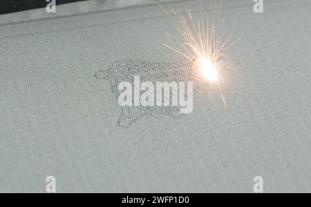 3D printer printing metal. Laser sintering machine for metal. Metal is sintered under the action of laser into shape. DMLS, SLM, SLS. Modern additive Stock Photo