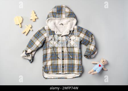 Warm baby coat for boys on gray background top view Stock Photo