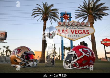 San Francisco 49ers, Kansas Chiefs helmets and the Vince Lombardi trophy at the Welcome to Fabulous Las Vegas sign, Tuesday, Jan. 30, 2024, in Las Veg Stock Photo