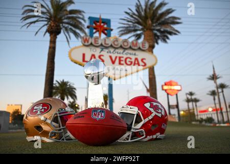 San Francisco 49ers, Kansas Chiefs helmets and the Vince Lombardi trophy at the Welcome to Fabulous Las Vegas sign, Tuesday, Jan. 30, 2024, in Las Veg Stock Photo